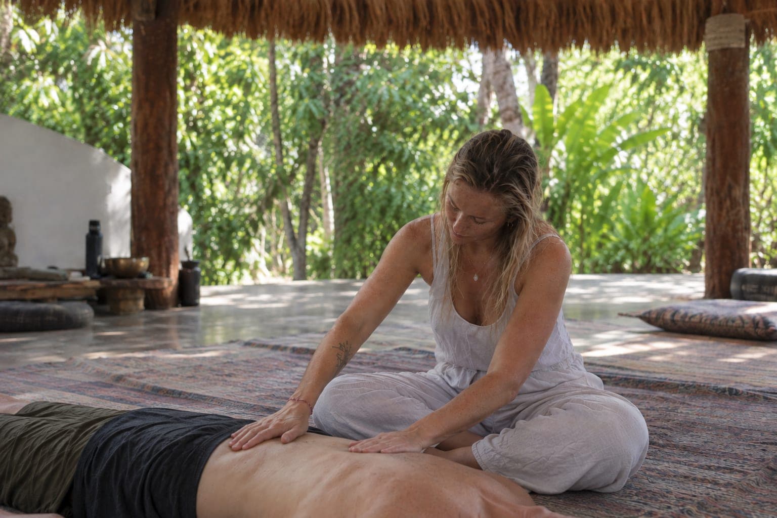 Bettina giving gentle bodywork in an open pavilion